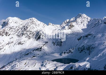 The mountains of Tartano Valley, near the town of Morbegno, Italy, during a beautiful winter day Stock Photo