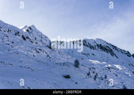 The mountains of Tartano Valley, near the town of Morbegno, Italy, during a beautiful winter day Stock Photo