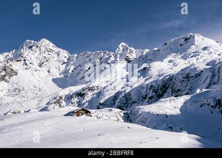 The mountains of Tartano Valley, near the town of Morbegno, Italy, during a beautiful winter day Stock Photo