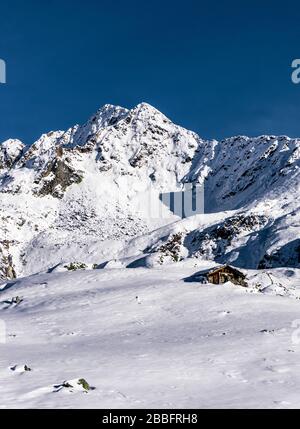 The mountains of Tartano Valley, near the town of Morbegno, Italy, during a beautiful winter day Stock Photo