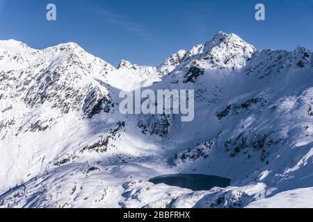 The mountains of Tartano Valley, near the town of Morbegno, Italy, during a beautiful winter day Stock Photo