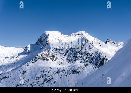 The mountains of Tartano Valley, near the town of Morbegno, Italy, during a beautiful winter day Stock Photo