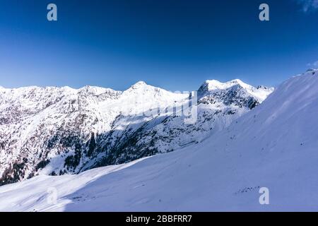 The mountains of Tartano Valley, near the town of Morbegno, Italy, during a beautiful winter day Stock Photo