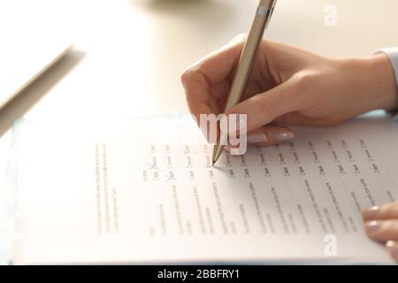Close up of executive woman hand filling out form on a desk at the office Stock Photo
