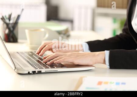 Close up of executive woman hands typing on laptop sitting on a desk at the office Stock Photo