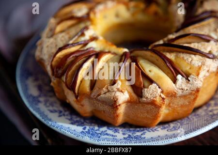 Round apple pie. Homemade pastries. Cupcake with apples on a wooden table. Simple food. Stock Photo