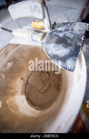 Top view of construction tools in bucket on concrete background. Set of assorted plaster trowel tools and spatula Stock Photo
