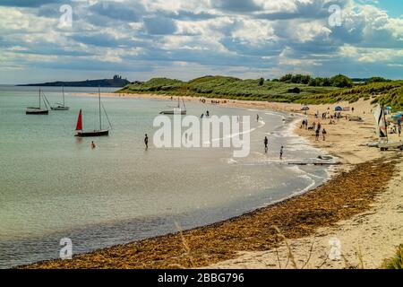 Sailing boats moored in the shallows on a warm summer day, Low Newton-by-the-Sea, Northumberland, UK. August 2018. Stock Photo