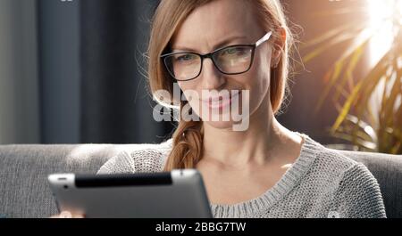 Adult woman using digital tablet Stock Photo