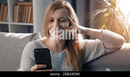 Happy woman using cellphone Stock Photo