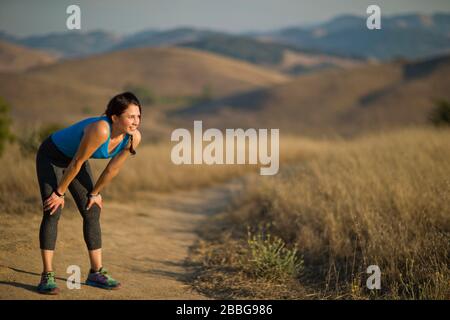 Mid adult woman taking a break while exercising Stock Photo