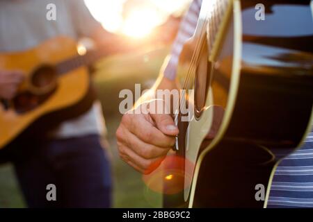 Father and son practicing playing guitar together Stock Photo