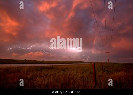 Storm with lightning flashing at sunset in rural Saskatchewan, Canada Stock Photo