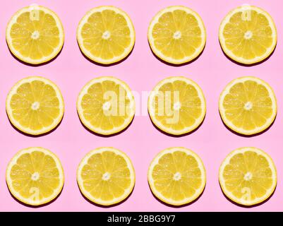 Fruit pattern. Slices of lemon on pink background Stock Photo