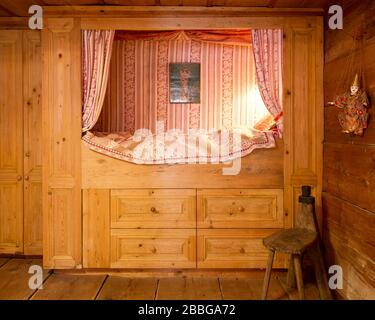 wooden alcove with bed, cushions and lamps Stock Photo