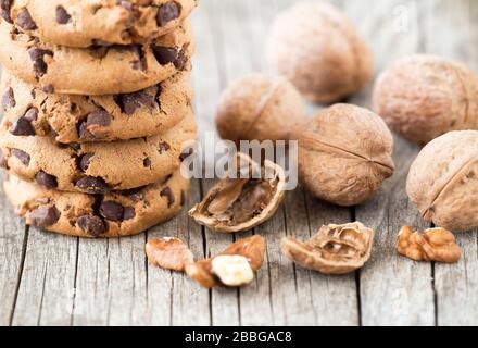 Chocolate chip cookies with walnuts on wooden background Stock Photo