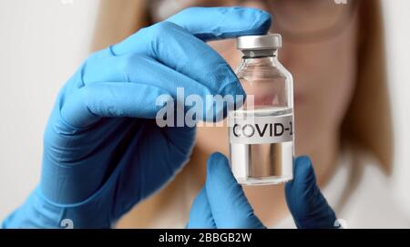 Doctor's hands holding vaccine bottle Stock Photo