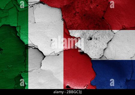 flags of Italy and Netherlands painted on cracked wall Stock Photo