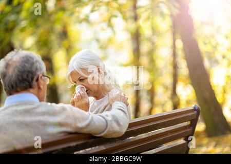 Depressed senior woman consoled by elderly man Stock Photo