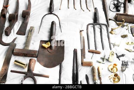 Antique iron cultivators and other vintage items on open air market of vintage things on the site of Red stone castle, Casta village, Slovakia Stock Photo