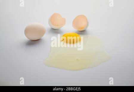 White broken chicken egg on a white background. Side view. Stock Photo