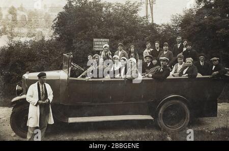 Vintage photo showing a group of tourists in 1931 in an oldtimer convertible bus on a visit in Lourdes, doing a day excursion from Cauterets, ready fo Stock Photo