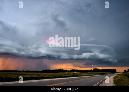 Lightning strikes with lenticular clouds over highway in rural southern Manitoba Canada Stock Photo