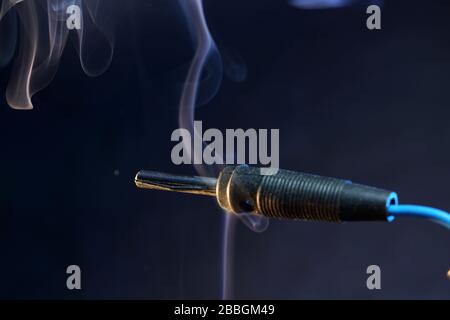 Electric wires with smoke photographed in the studio Stock Photo