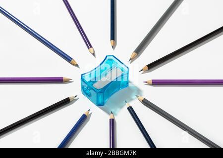 Multicolored pencils and sharpener isolated on white background. Copy space for text. Back to school concept Stock Photo
