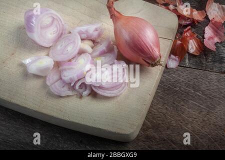 studio shot of challot onions on wooden cutting desk Stock Photo