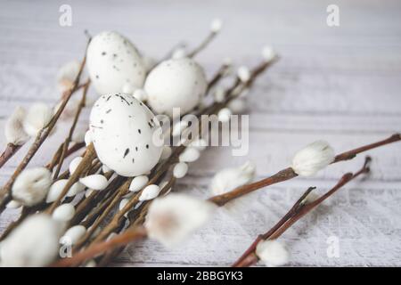 Easter decorations. Willow twigs and decorative Eggs on wooden background Stock Photo