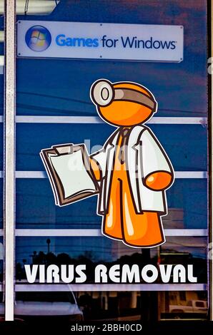 A computer store advertises virus removal, March 29, 2020, in Theodore, Alabama. Computer viruses replicate themselves by modifying computer programs. Stock Photo
