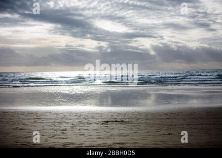 Cloudy Blue Sky with Rays of Sun Lights on a Beach Stock Photo