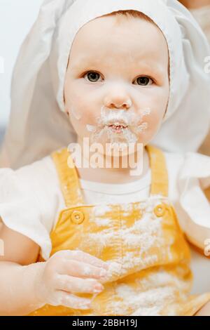 Close-up portrait of charming little girl in white cap Stock Photo