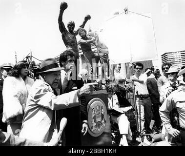 Photograph of Sylvester Stallone and Burgess Meredith filming Rocky III in Philadelphia, PA in 1982.Credit:  Scott Weiner / MediaPunch Photograph of the Premiere of Rocky II at the Philadelphia Museum of Art in Philadelphia, PA in 1979. Stock Photo