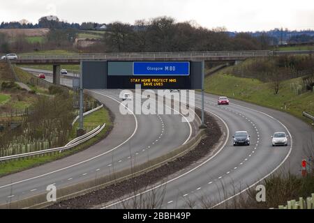 Cumbernauld, Scotland, UK. 31st Mar, 2020. Pictured: Motorway signs display the message, “STAY HOME PROTECT NHS SAVE LIVES” during the UK lockdown to stop the spread of the Coronavirus in which 1,993 people have now tested positive for the virus and 60 people have died from the virus. Credit: Colin Fisher/Alamy Live News Credit: Colin Fisher/Alamy Live News Stock Photo
