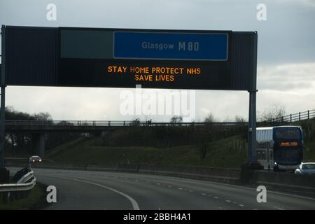 Cumbernauld, Scotland, UK. 31st Mar, 2020. Pictured: Motorway signs display the message, “STAY HOME PROTECT NHS SAVE LIVES” during the UK lockdown to stop the spread of the Coronavirus in which 1,993 people have now tested positive for the virus and 60 people have died from the virus. Credit: Colin Fisher/Alamy Live News Stock Photo