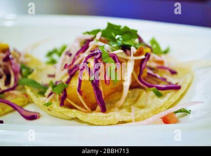 delicious fried fish tacos covered in cabbage and cilantro Stock Photo