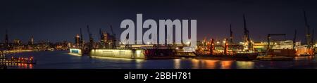 Panorama of Hamburg harbour at night Stock Photo