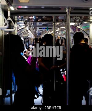 Passengers in Singapore Mass Rapid Transit (MRT) train. The MRT has 102 stations and is the second-oldest metro system in Southeast Asia Stock Photo