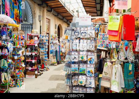 LARNACA, CYPRUS - FEBRUARY 16, 2019: Colorful gifts magnets, kitchen towels on stands at souvenir market in Larnaca touristic downtown Stock Photo