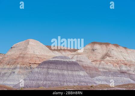 Low angle landscape of badlands or striped barren hills at Petrified Forest National Park in Arizona Stock Photo