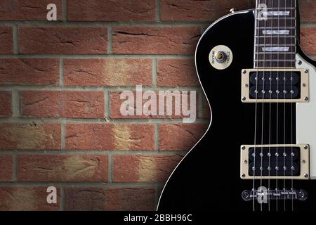 Vintage electric guitar on brick background with copy space Stock Photo
