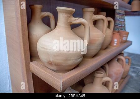There are several traditional jugs on the shelf. Stock Photo