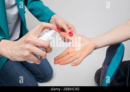 Close up of mother applying antiseptic gel for son Stock Photo