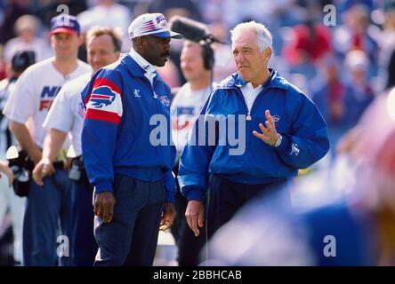 Former Buffalo Bills' head coach Marv Levy, center, stands with former  players Ruben Brown, left, and Leonard Smith, right, during a halftime  ceremony honoring former Bills' general manager Bill Polian at their