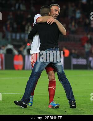 Bayern Munich's Franck Ribery celebrates at the final whistle with a pitch invader Stock Photo