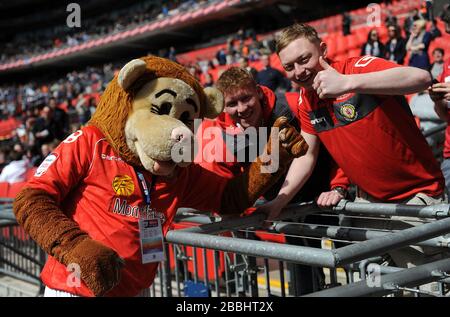 Crewe Alexandra mascot Gresty the Lion with fans before the kick off Stock Photo