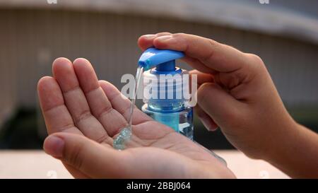 Children washing hands with alcohol based gel to protect from corona ...