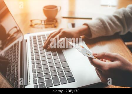 A young woman makes an online payment for a purchase. Stock Photo